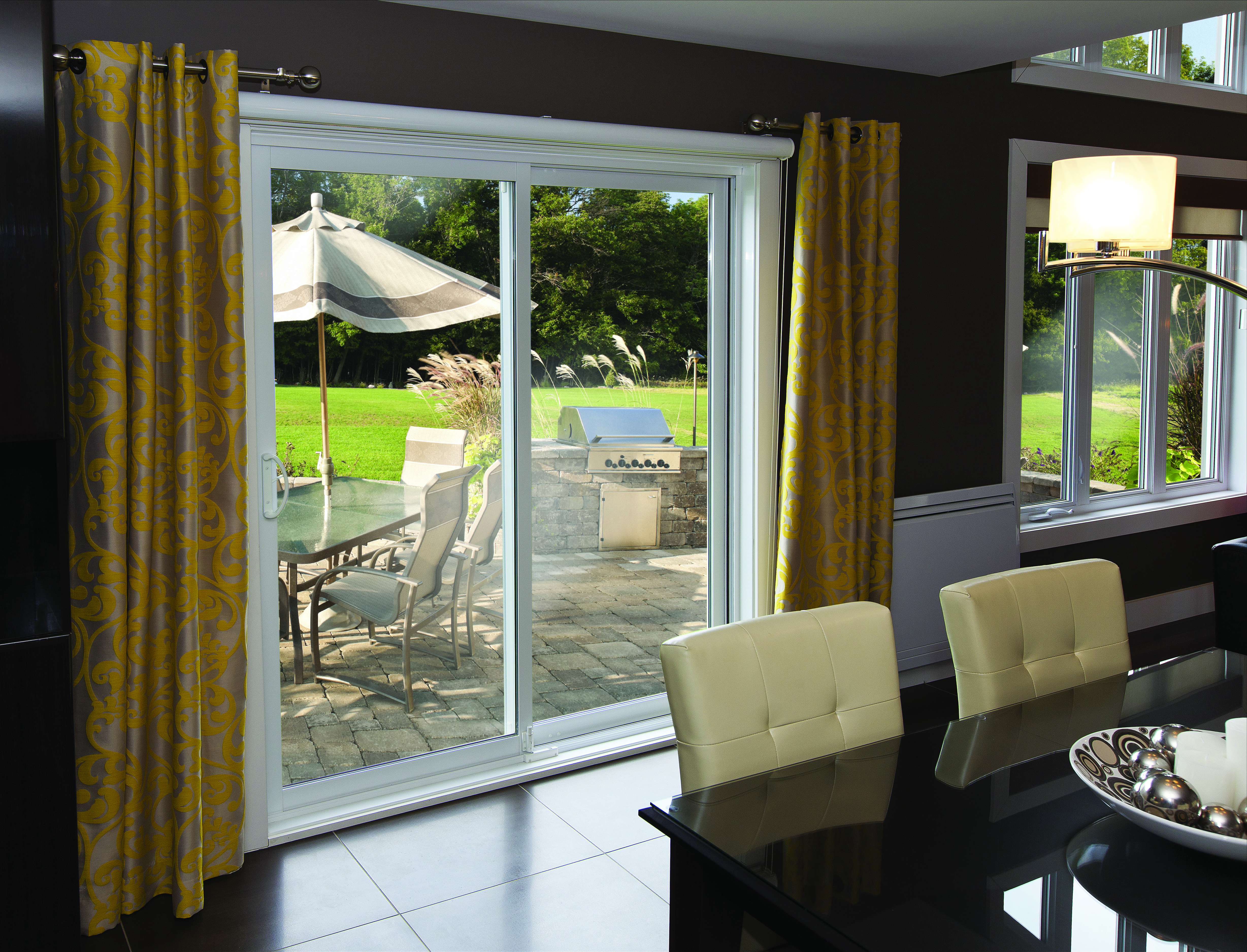 An elegant dining room with a sliding patio door looking into the backyard.