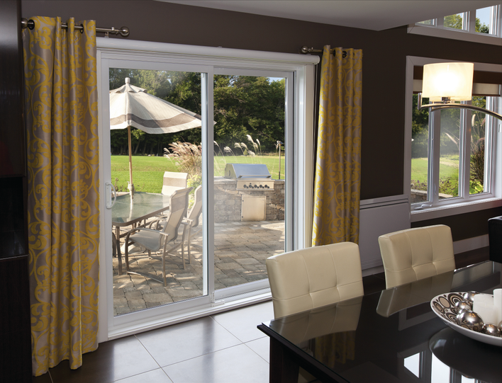 An elegant dining room with a sliding patio door looking into the backyard.