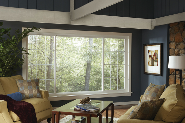 A living room with large, eco-friendly windows that make it a more sustainable and energy-efficient home.