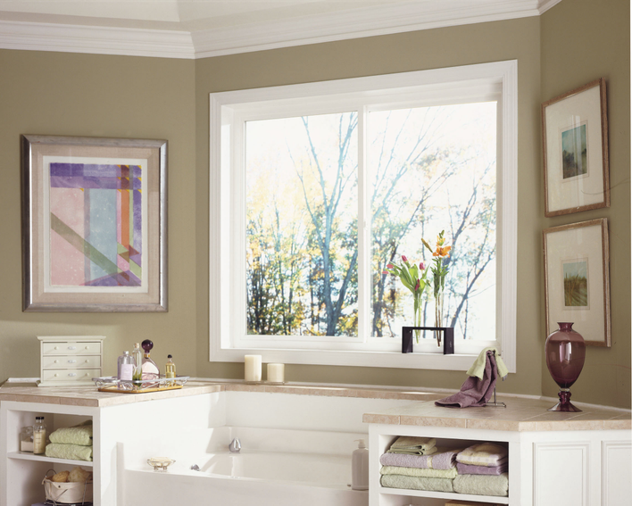 Custom home windows in the bathroom above the bathtub.