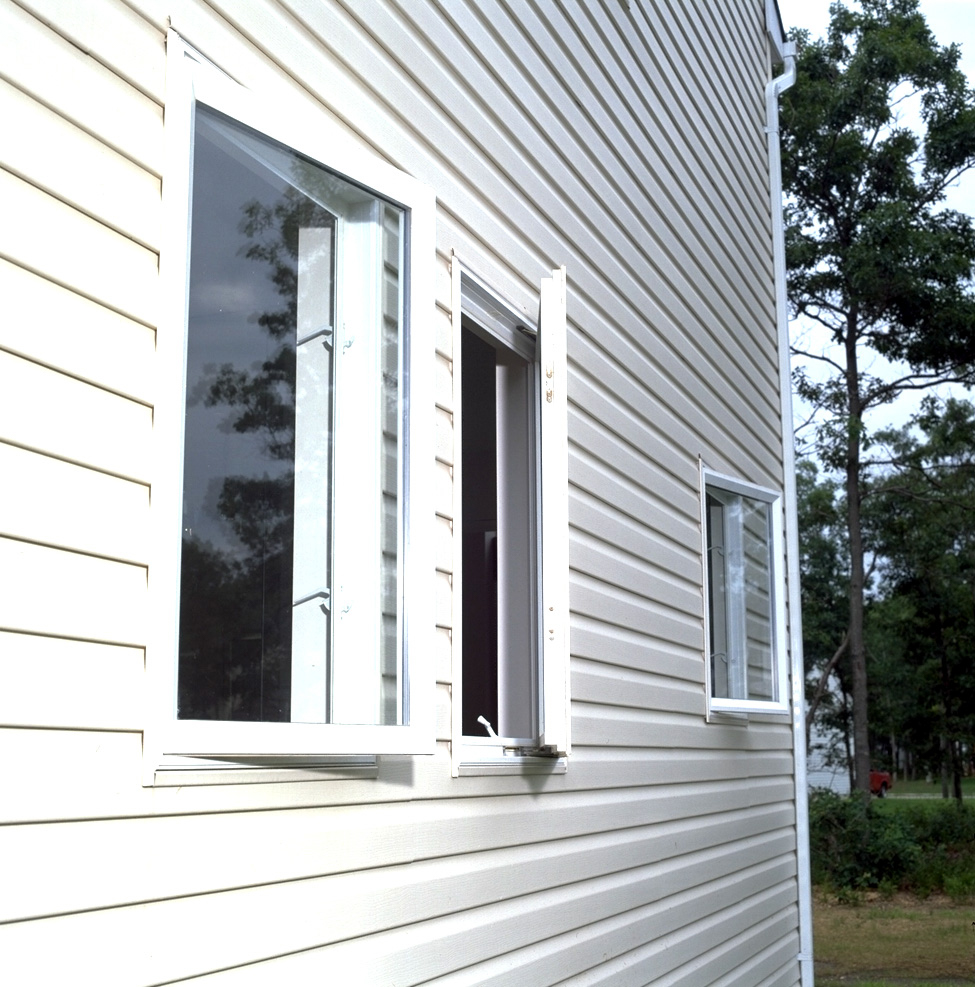Multiple open casement windows seen from a home’s exterior
