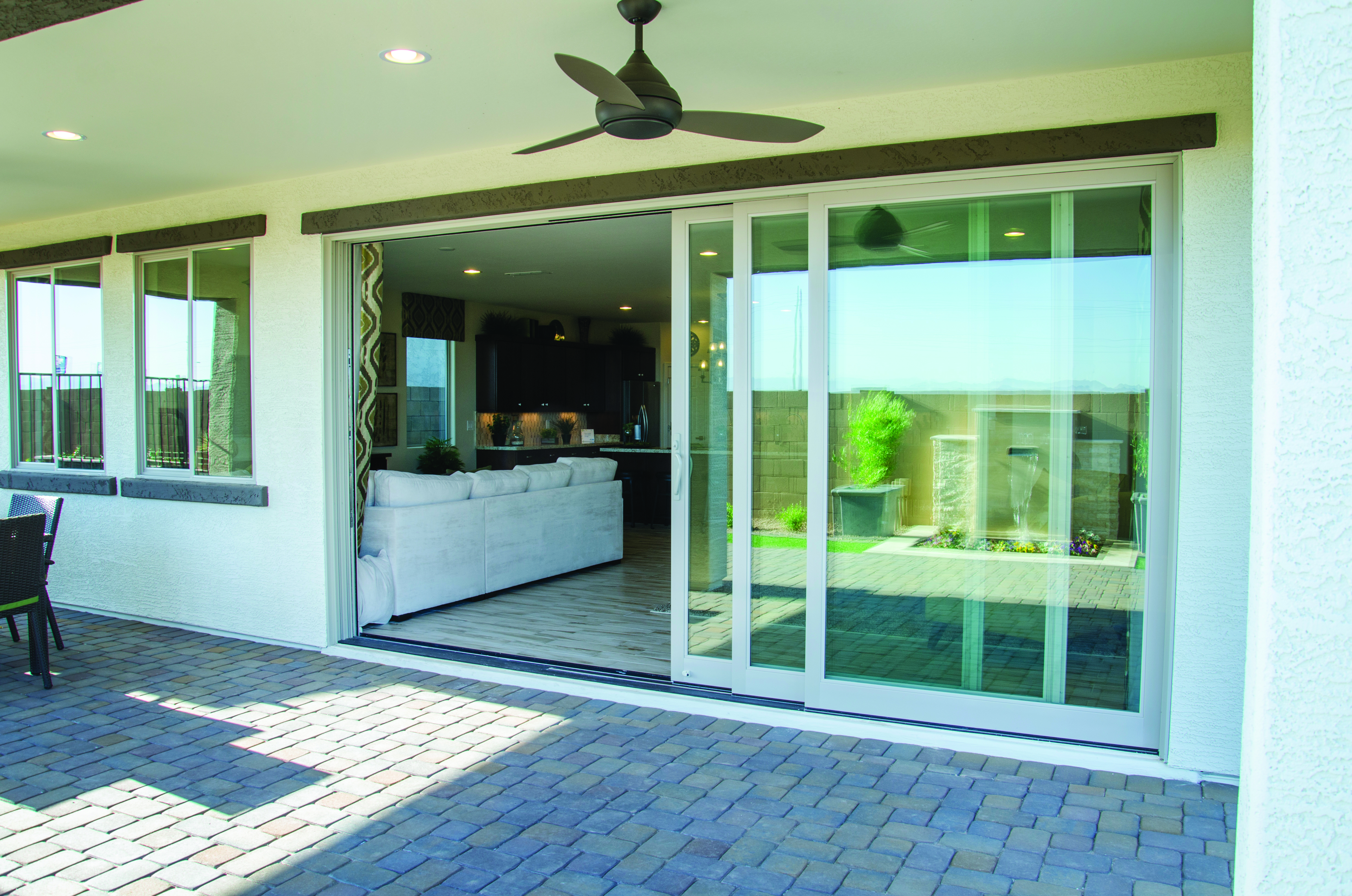 An open sliding patio door looking into the living room of a home.