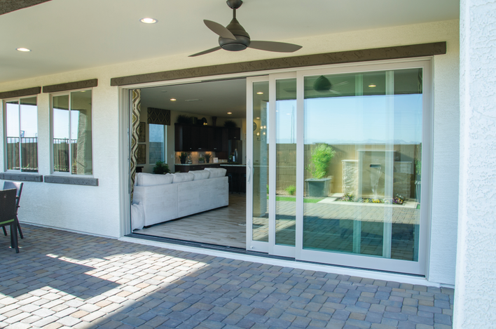 An open sliding patio door looking into the living room of a home.