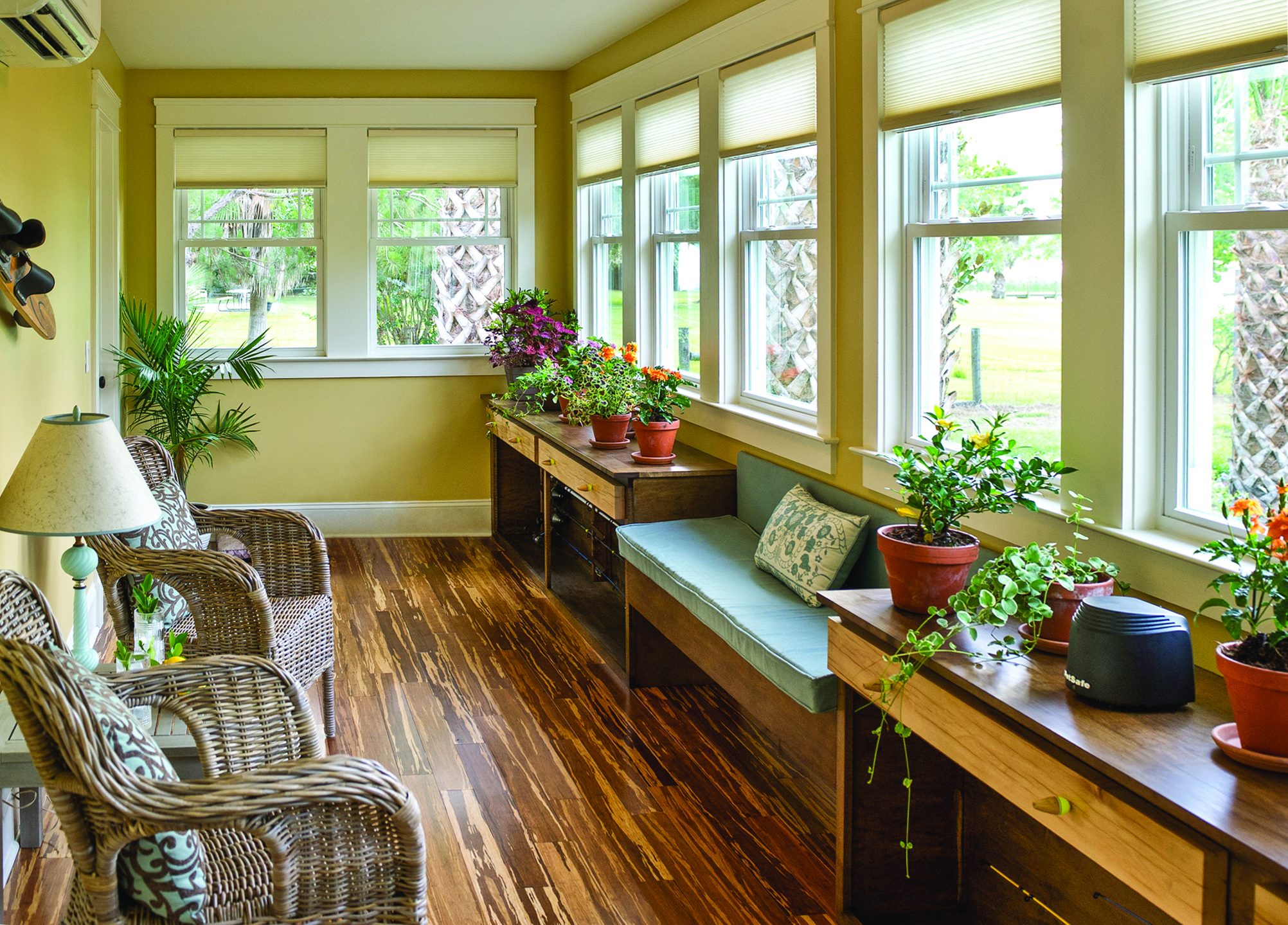 A sunroom full of double-hung windows, some of which won’t stay up and will need to be fixed.