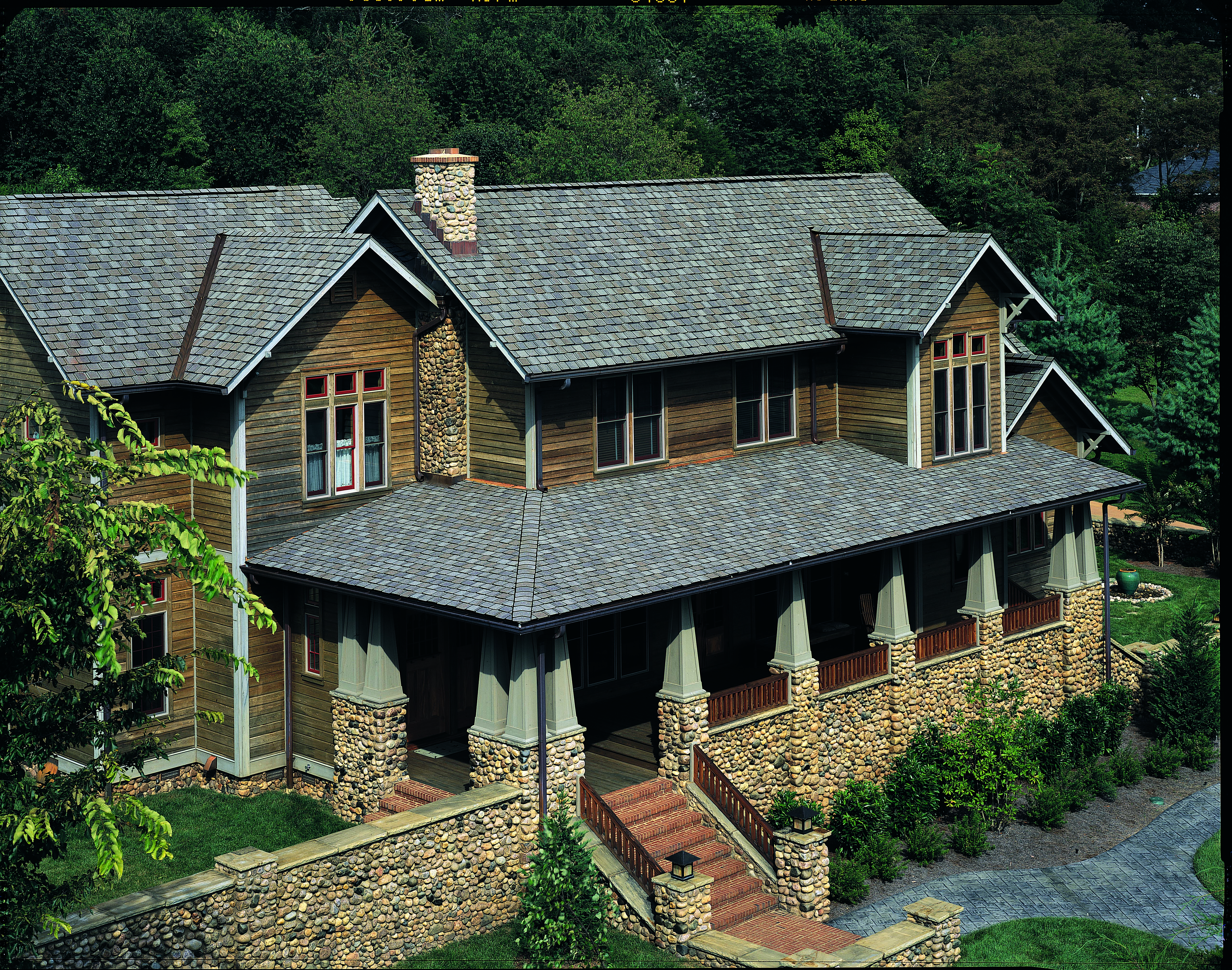 Rustic 2 story home with CertainTeed's Grand Manor shingle line in Stonegate Gray.
