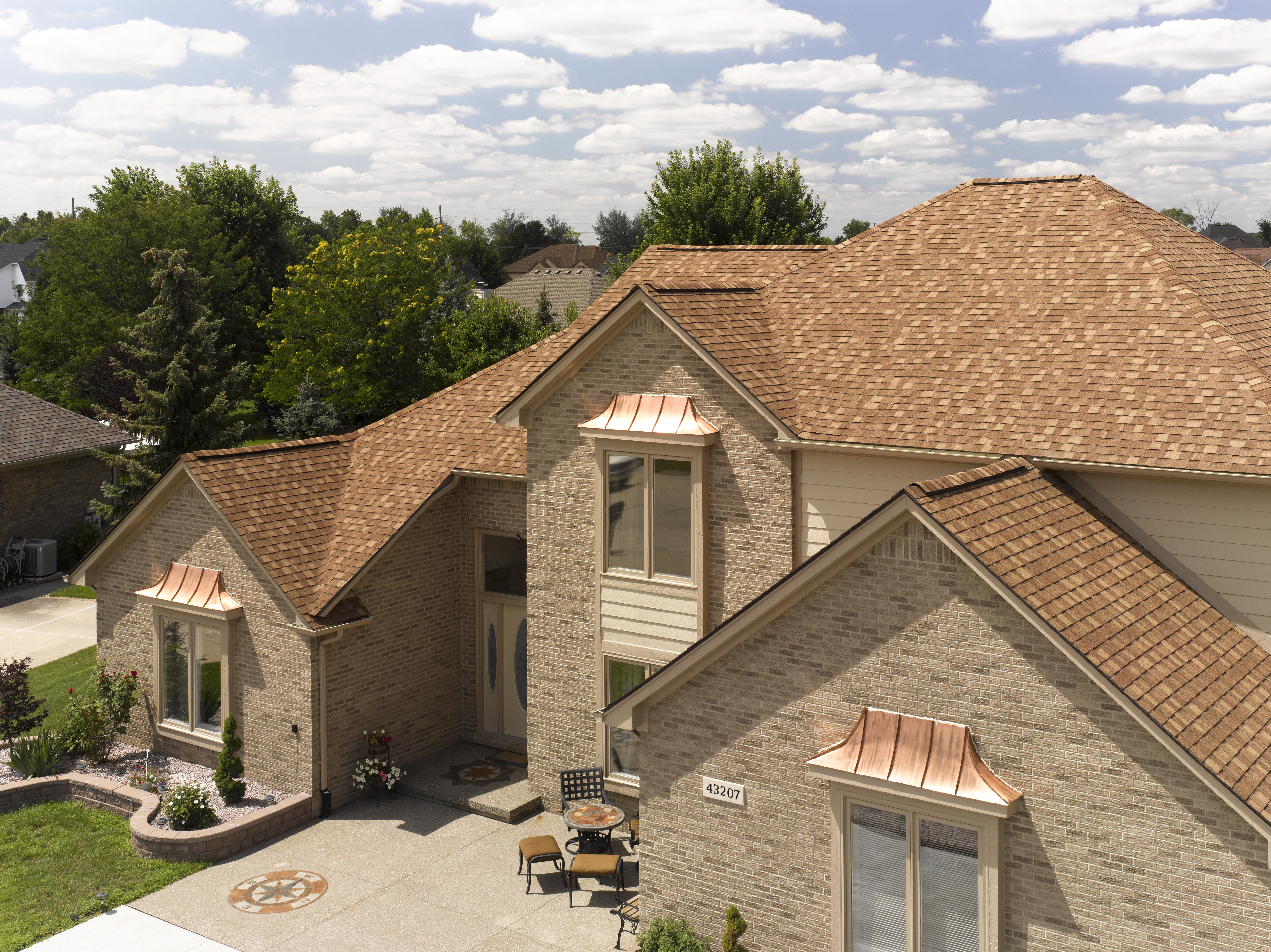 2 story brick home with the CertainTeed's Landmark shingle line in the color Resawn Shake.