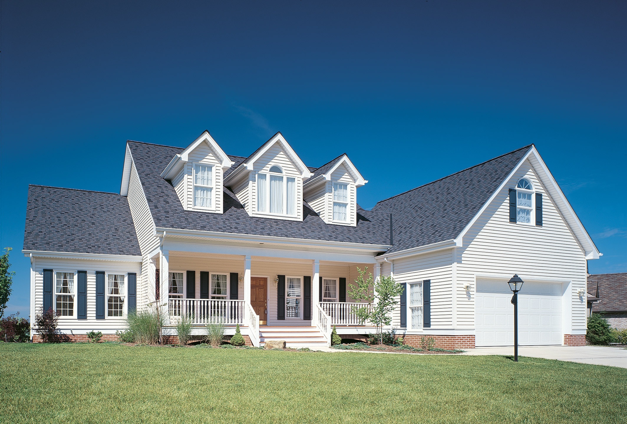 House with blue shutters and off-white siding, another popular shutter color combination.