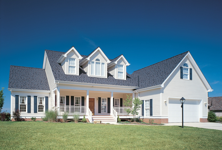 House with blue shutters and off-white siding, another popular shutter color combination.