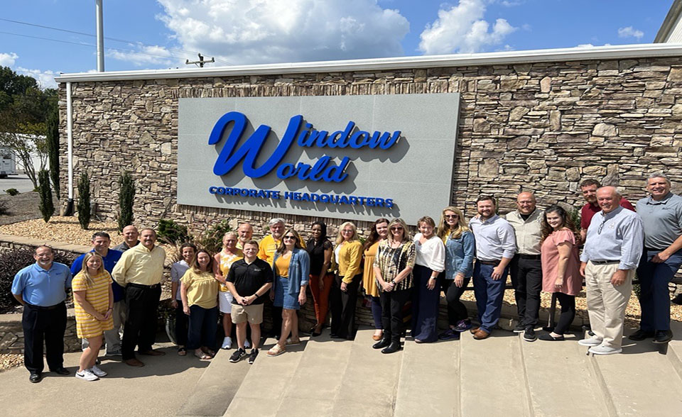 Window World Corporate employees standing in front of the sign of the corporate office
