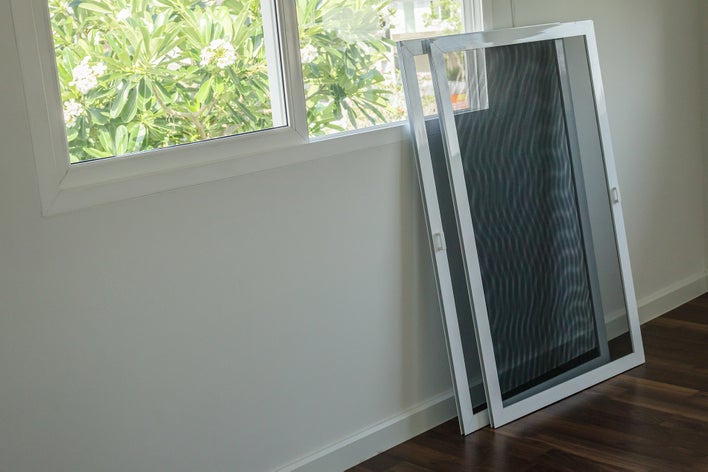 Window screen replacements ready to install on a sliding window