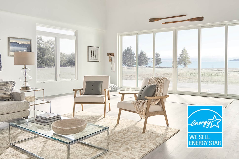 Living room with energy star sliding glass doors and picture windows