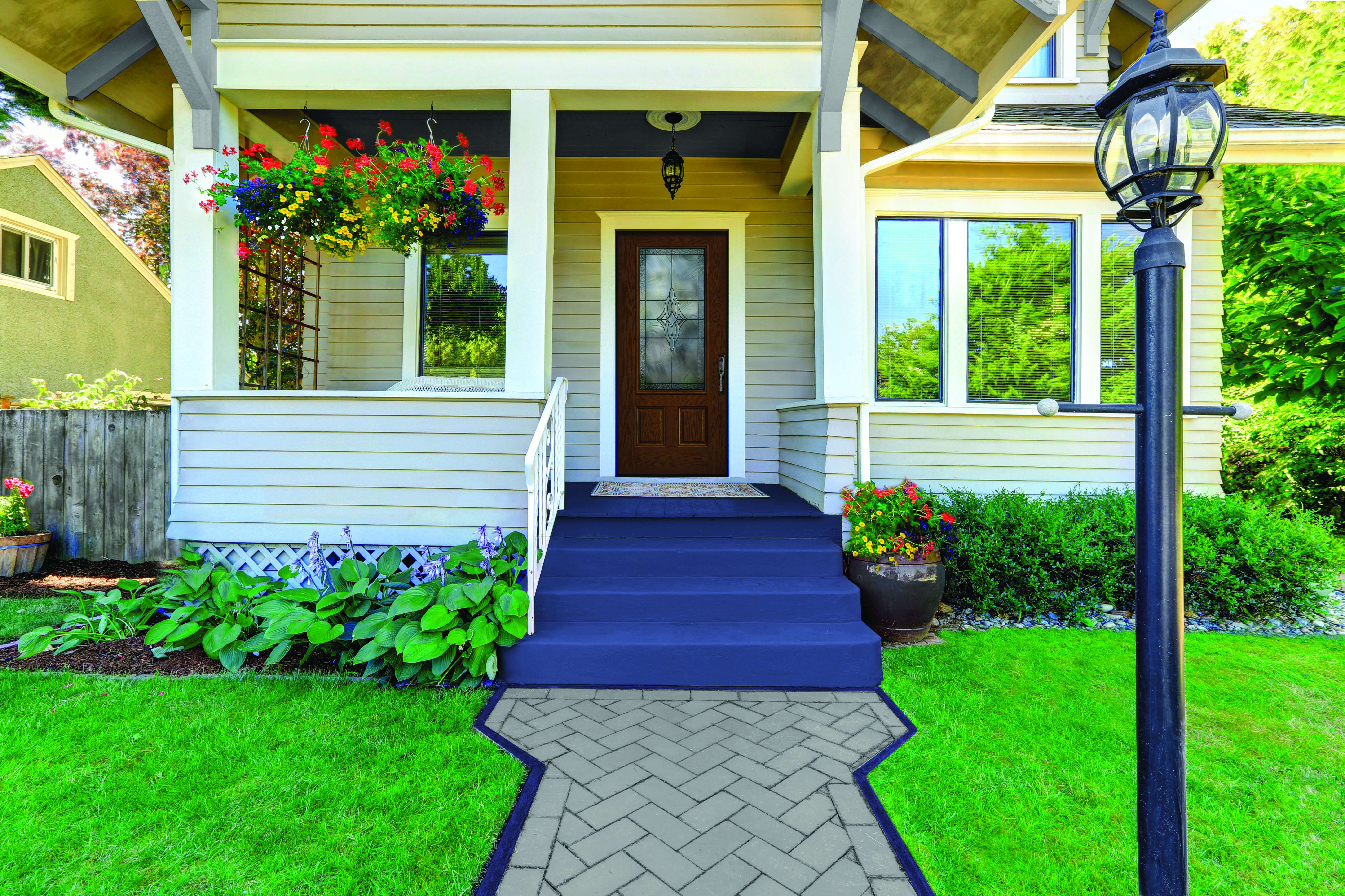 A New-Earth colored Fiber-Classic® Fiberglass Entry Door on a quaint porch