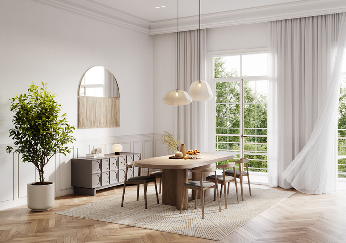 Dining room table in front of glass patio doors in a room with high ceilings.