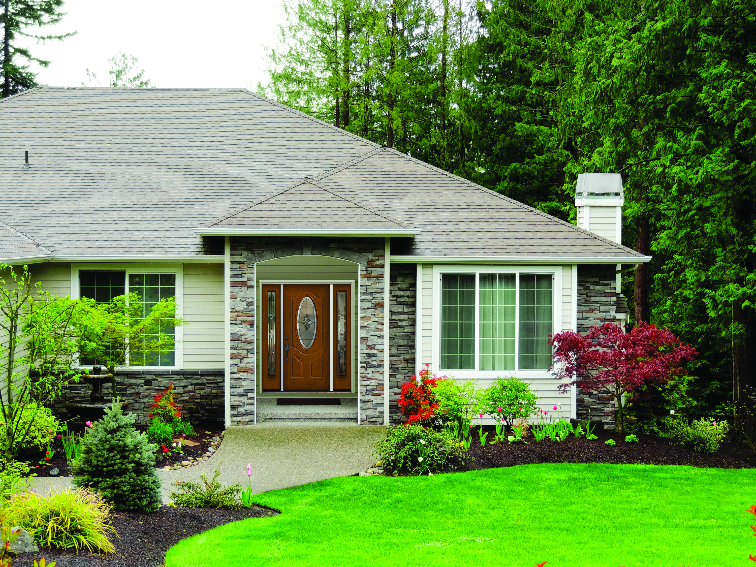 The front view of a well-maintained home, including its energy-efficient front door