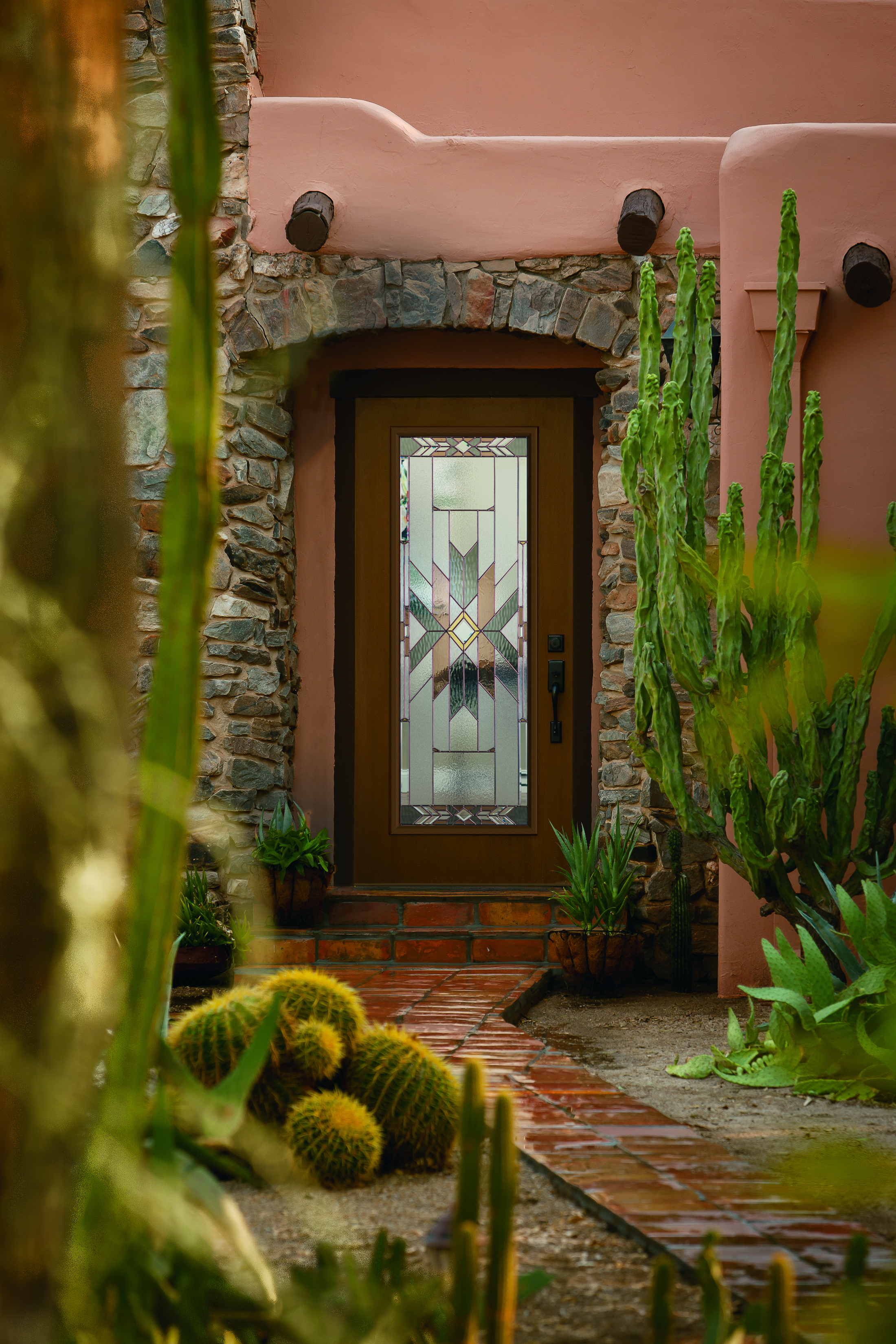 full lite woodgrain entry door with mohave decorative glass on a home with stucco and stone accents