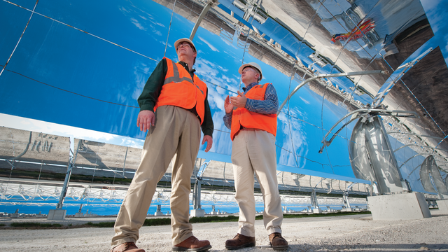 Maintenance workers under a solar panel