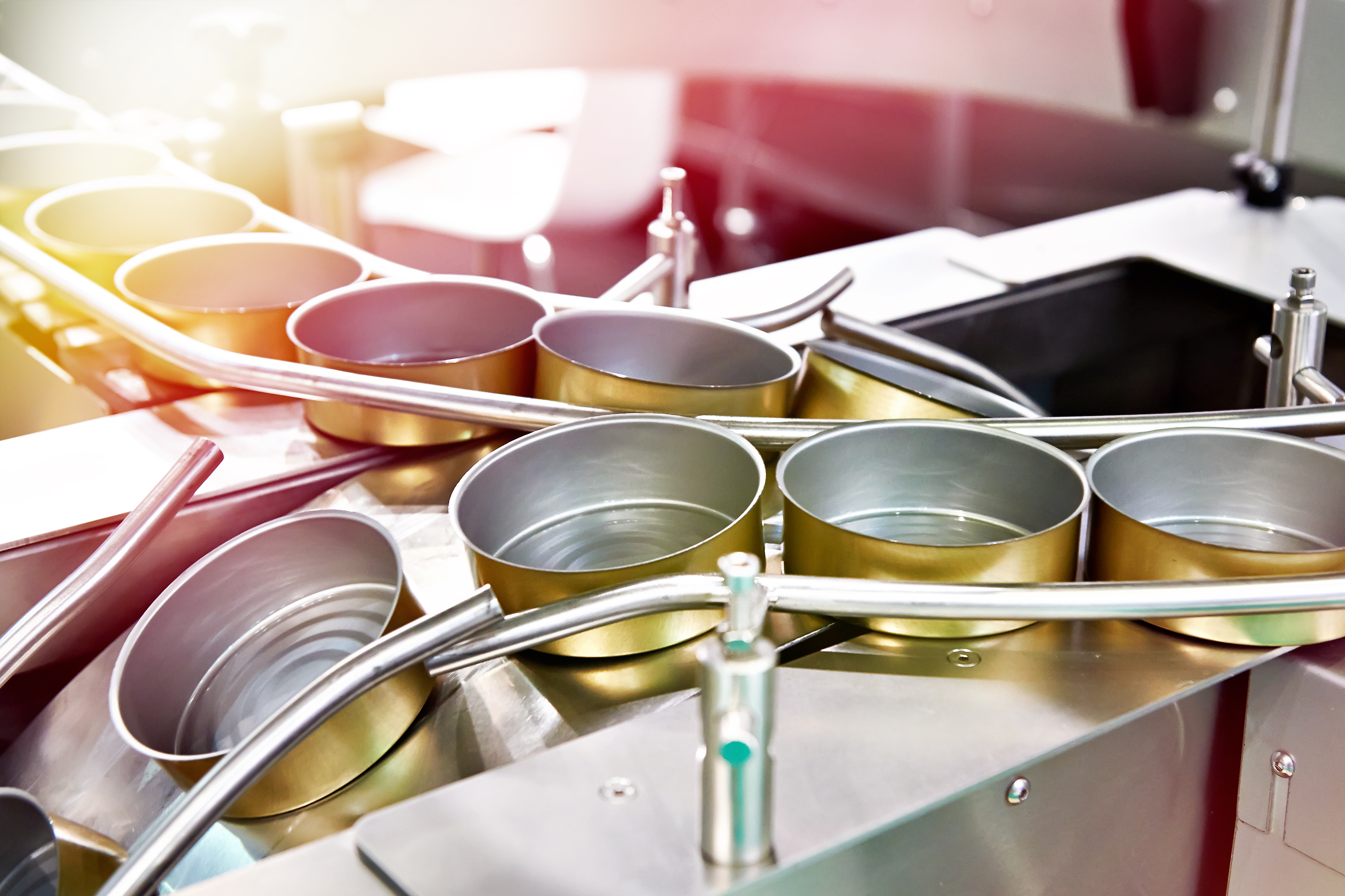 Empty cans on conveyor of food factory