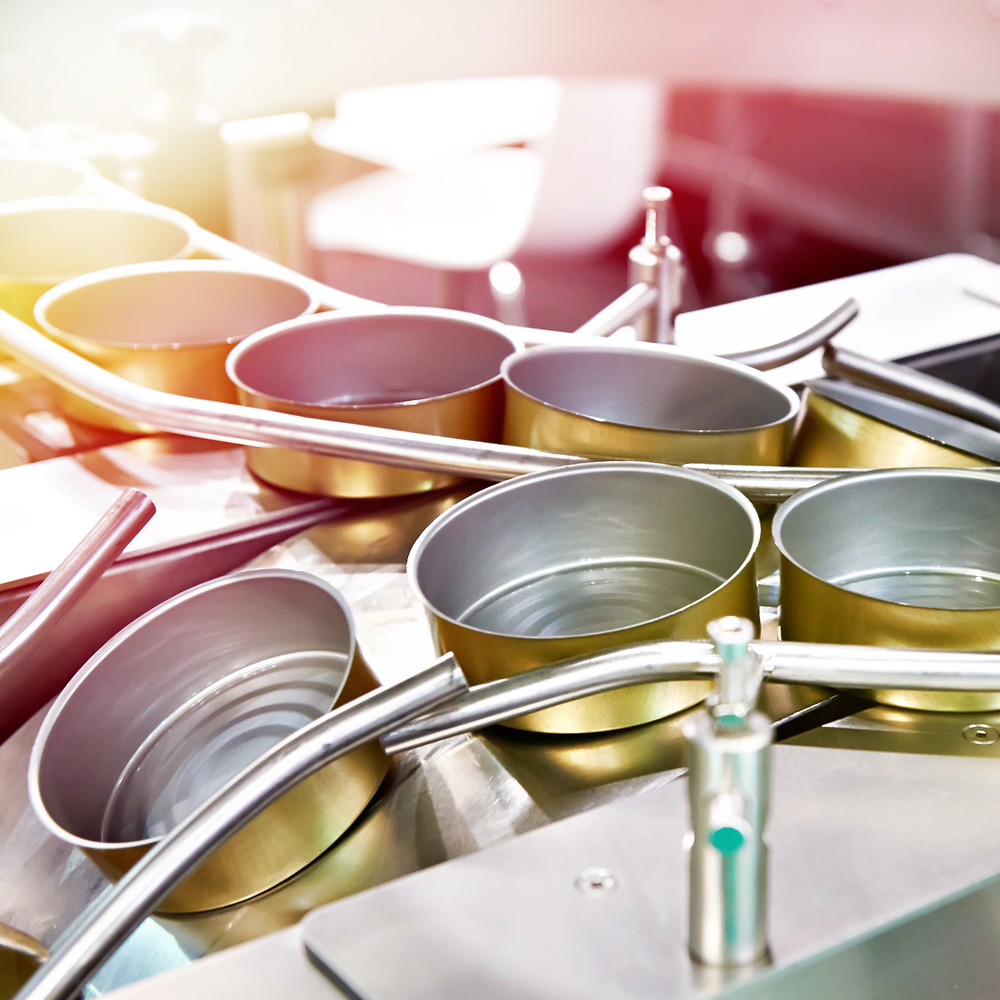 Empty cans on conveyor of food factory