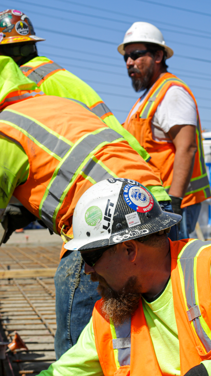 Three men working on ev project site