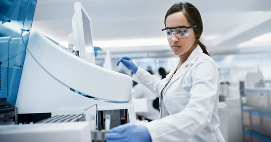 Woman working in a laboratory with chemicals 