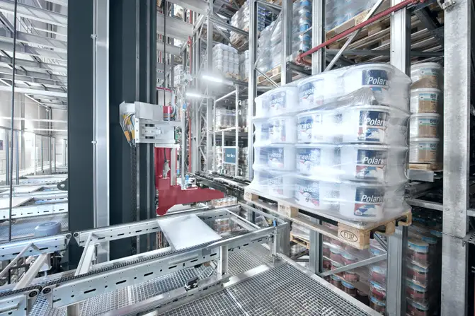 Stacker crane storing a pallet with paint buckets