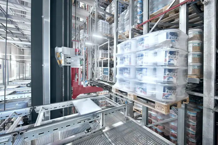 Stacker crane storing a pallet with paint buckets