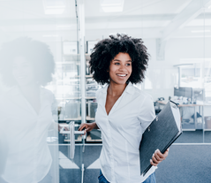 Woman in an office with a folder in hand