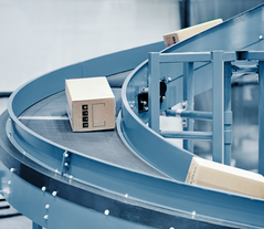 Cartons with customer orders on a conveyor 