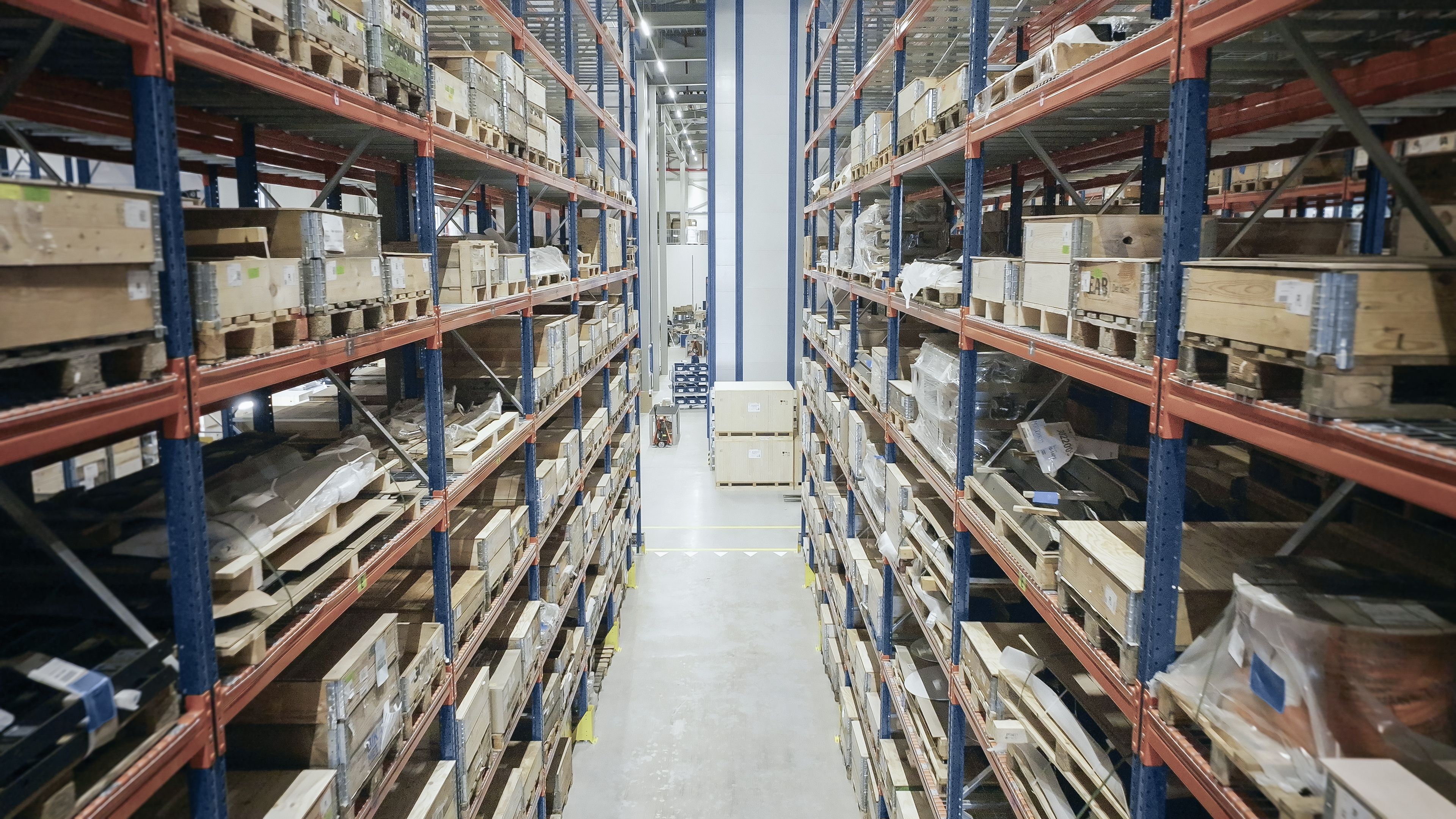 Industrial warehouse with high-density storage racks and inventory pallets.