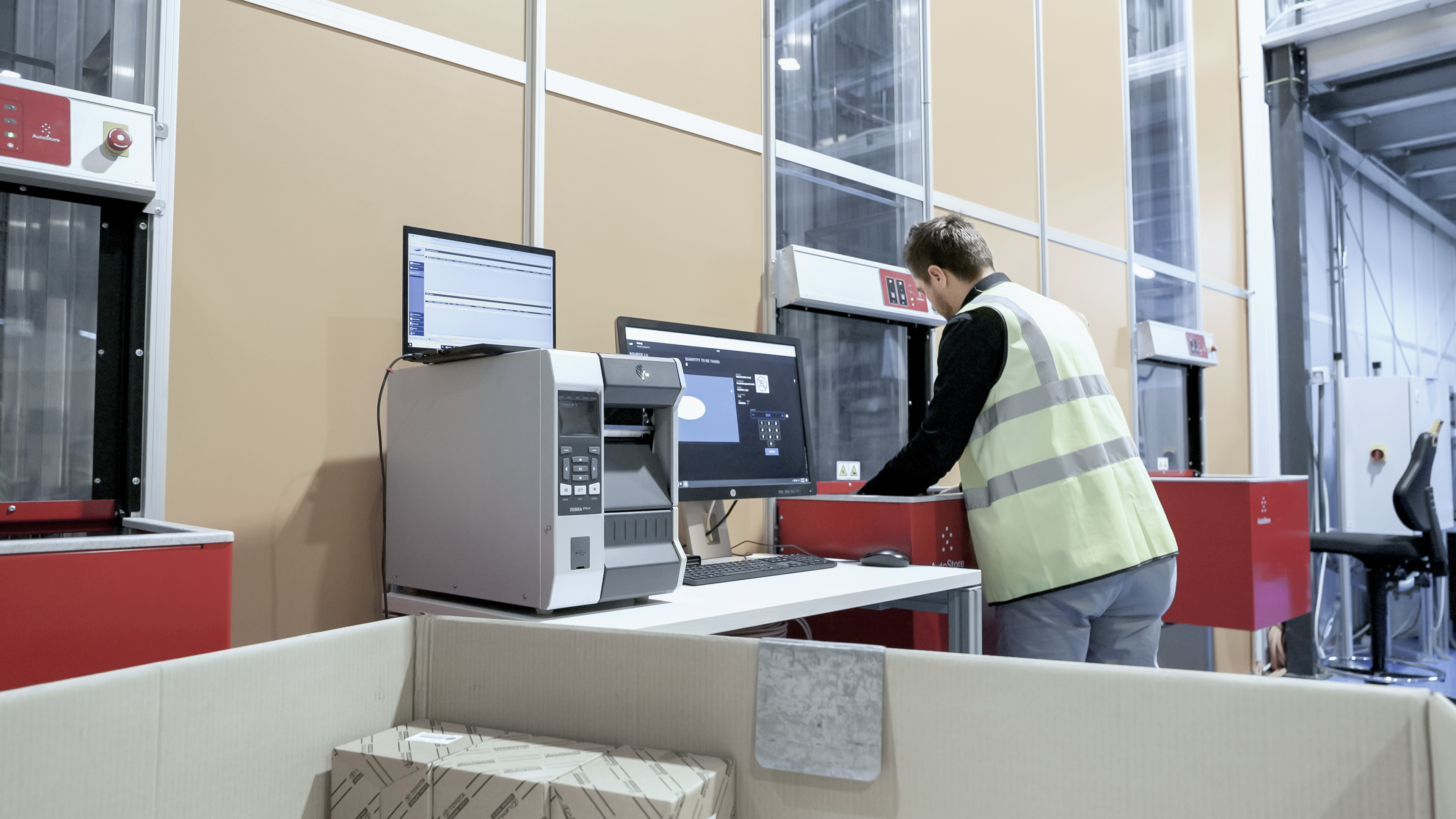 Operator picking out of AutoStore system in warehouse