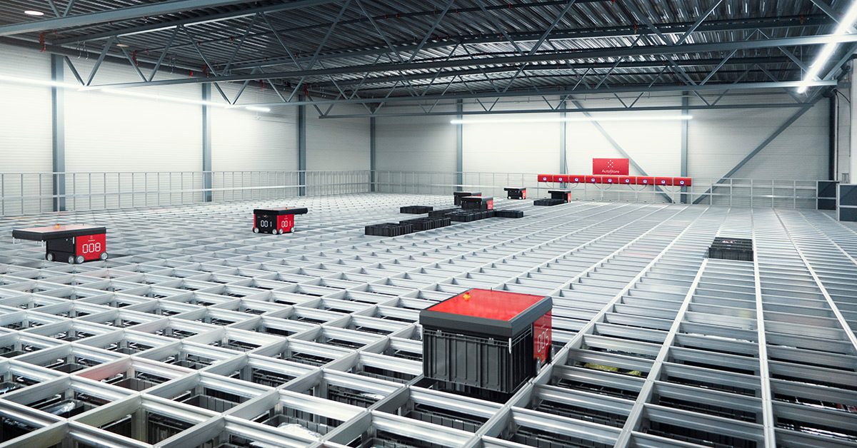 Red AutoStore robots moving on metal grid