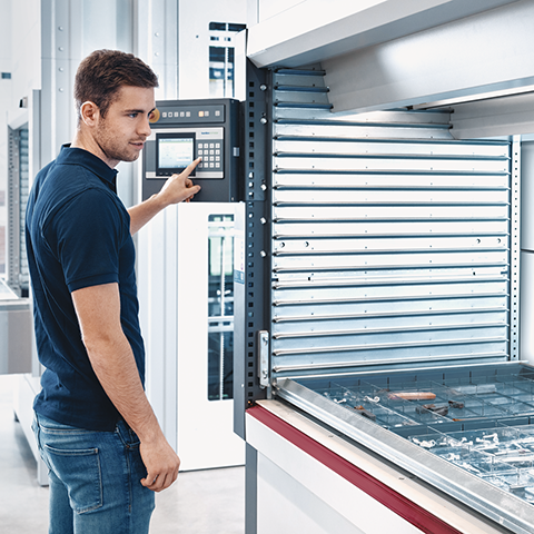 Man works on the Shuttle XP equipped with Kardex VLM Boxes