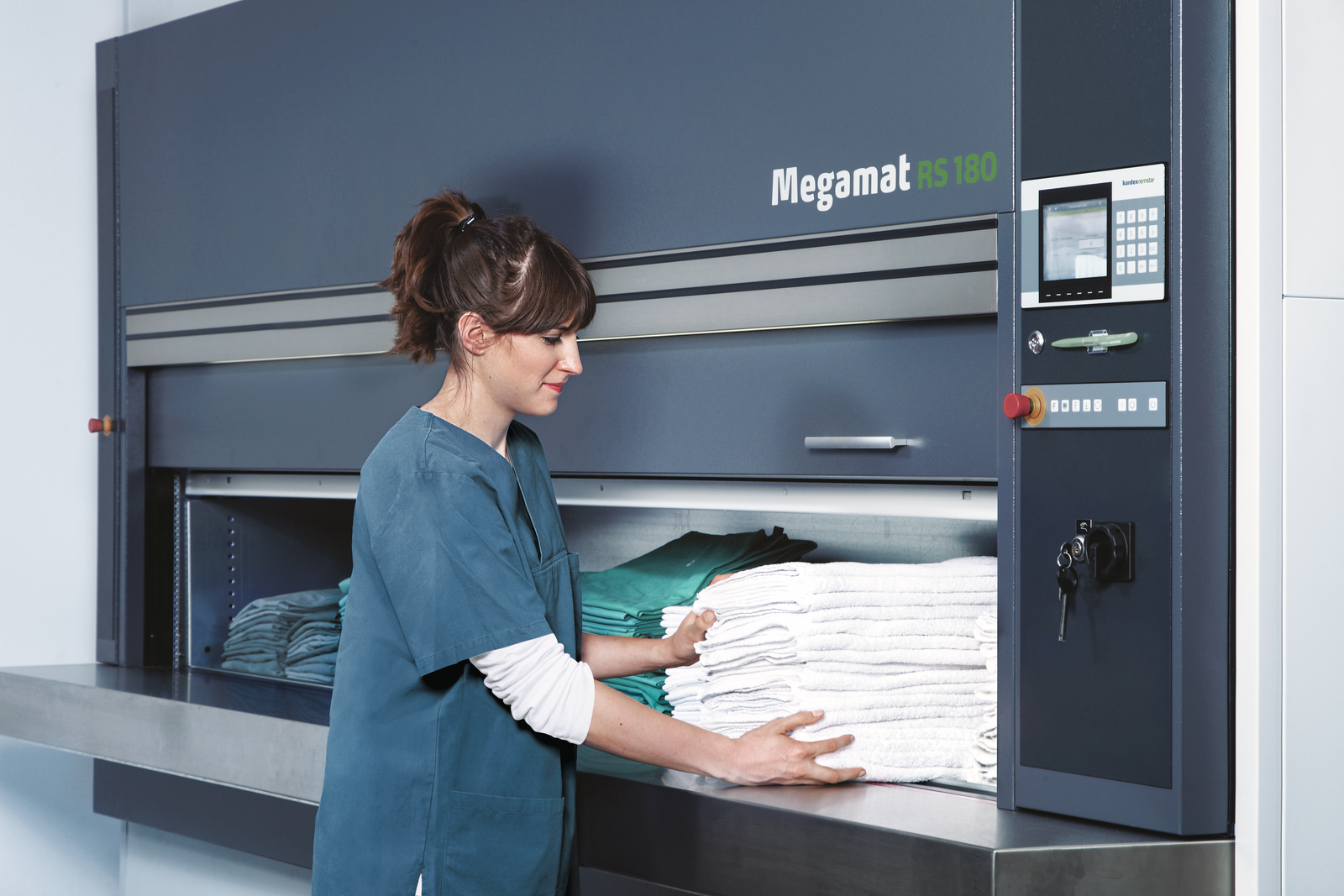 woman storing hospital supplies in kardex megamat 