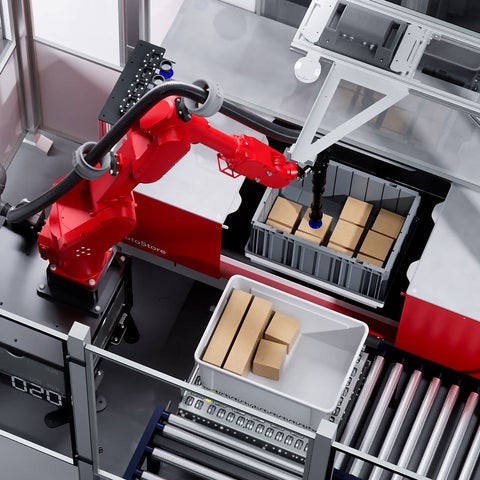Red robotic arm picking boxes from AutoStore bin at port