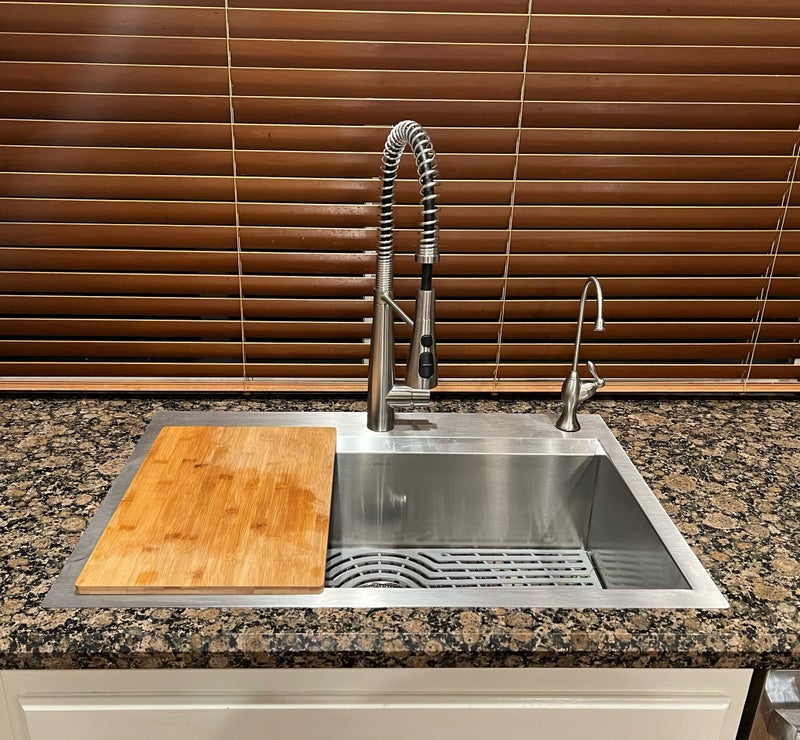 A new kitchen sink after installation by a professional plumbing contractor