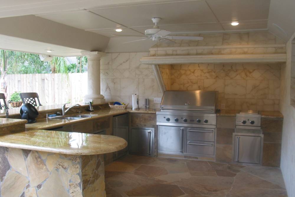 Sophisticated outdoor kitchen with stainless steel appliances and stone elements