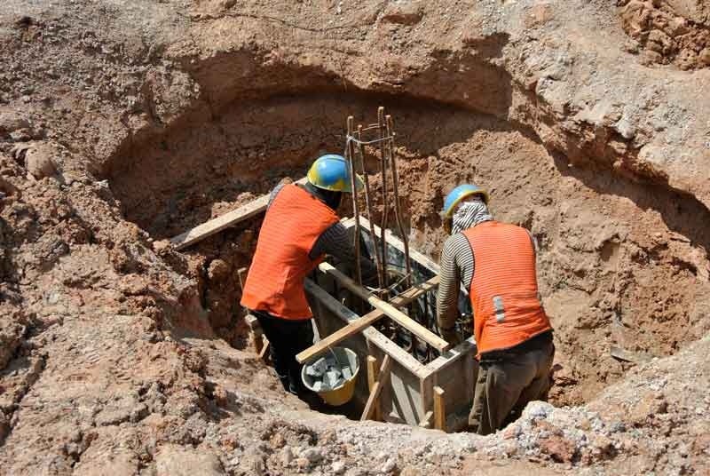 Two professional doing foundation repair work