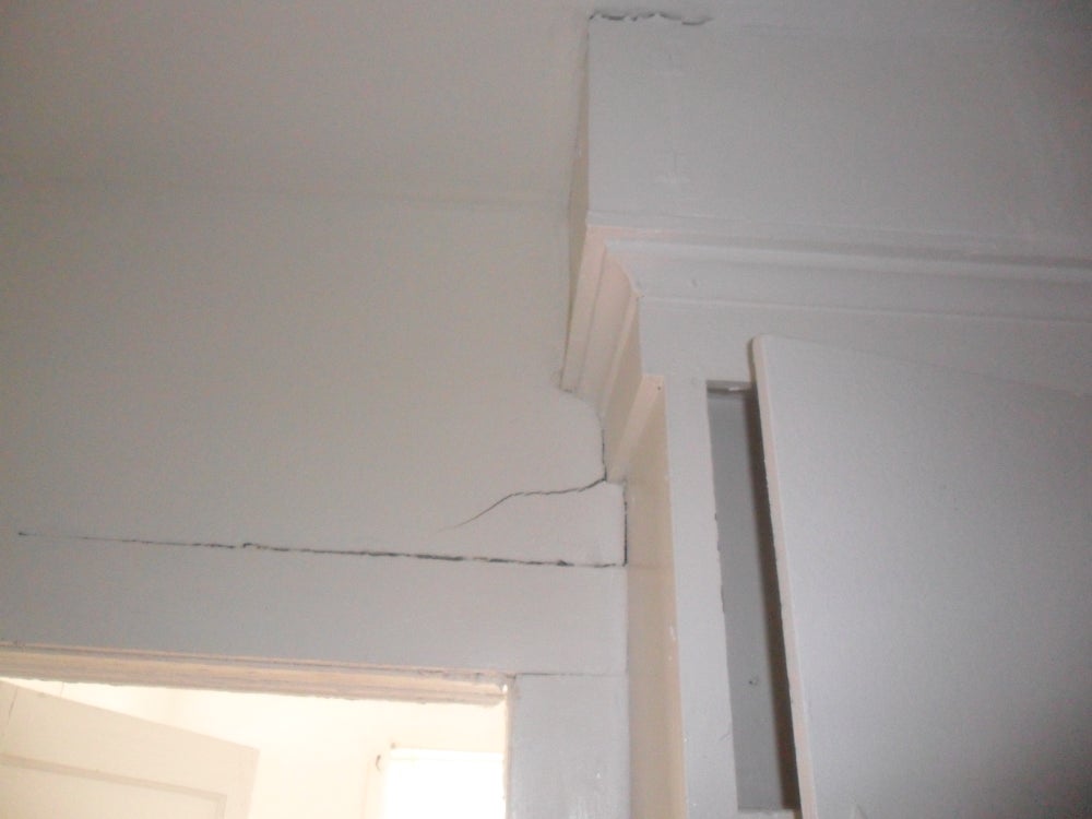 A house with visible foundation cracks and damage