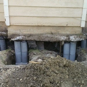Exposed house foundation repair with temporary supports