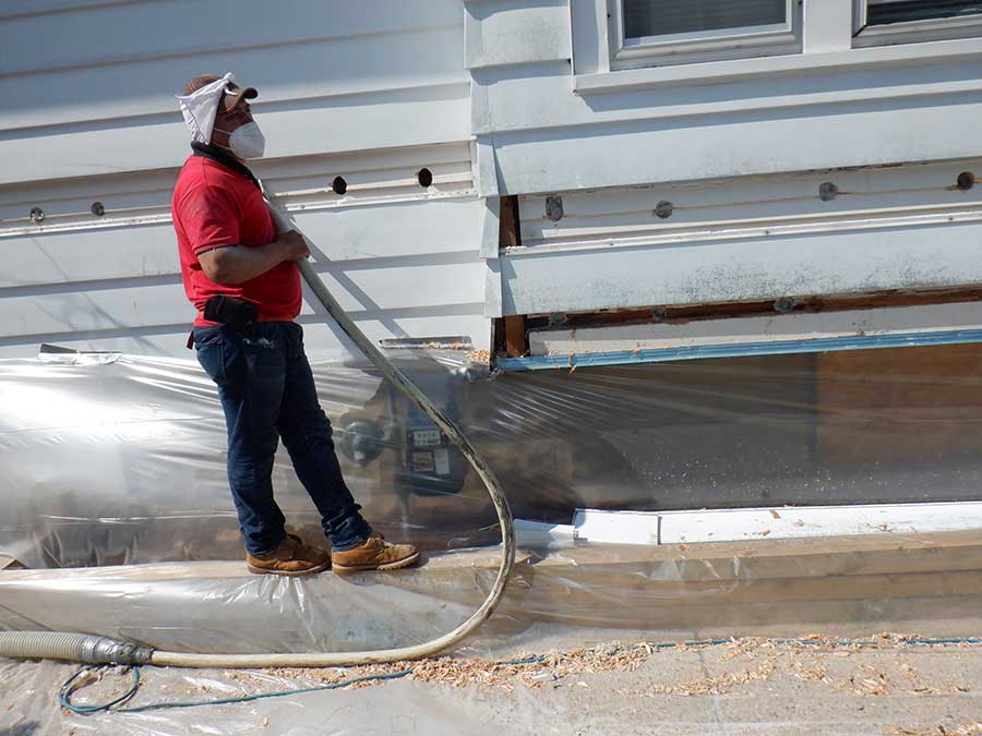 A professional insulation contractor working on a Milwaukee home