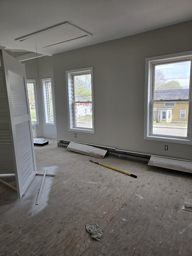 Home renovation nearing completion with flooring and trim needed.