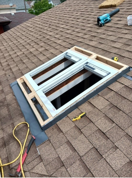 Professional installation of a new residential skylight on a shingled roof in Chicago