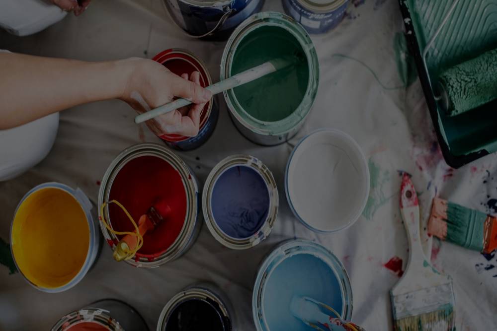 Interior house painting with multicolored paints and brushes
