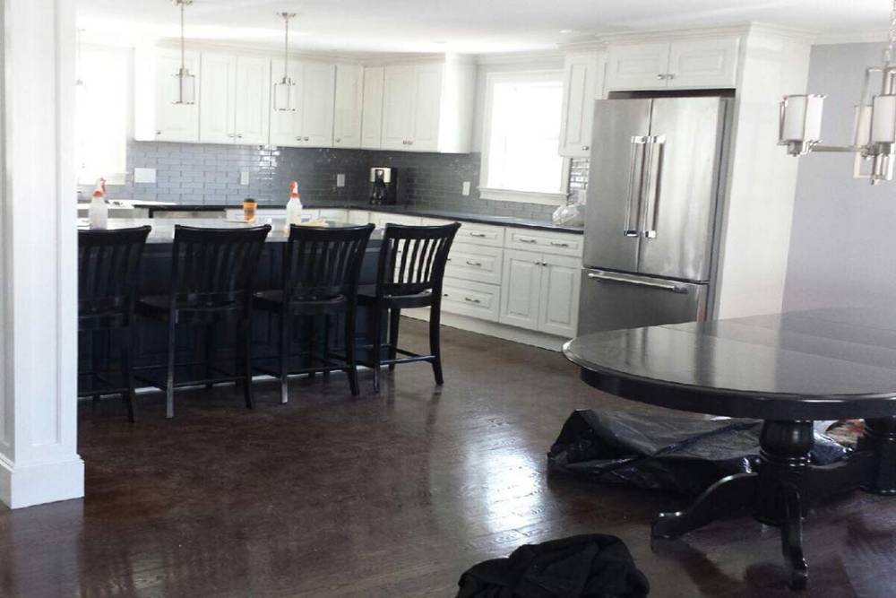 Freshly painted modern kitchen with white cabinets and stainless steel appliances