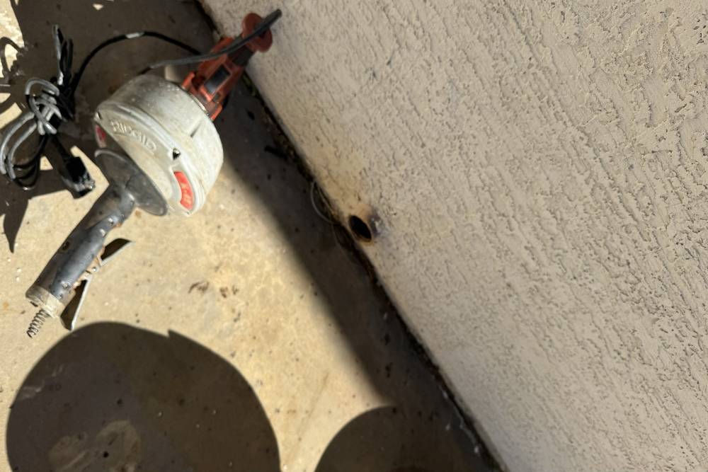 Commercial drain camera inspection tool near exterior wall