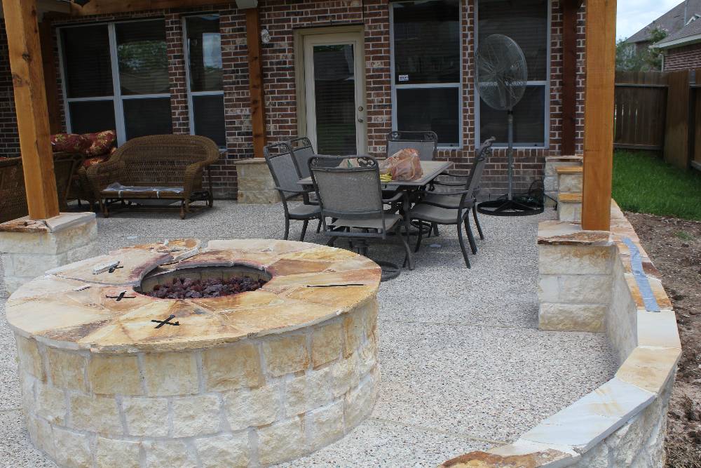 Outdoor living space with stone fire pit and patio furniture