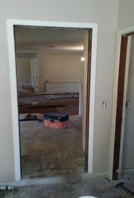 Concrete foundation repair in progress with interior remodeling underway.