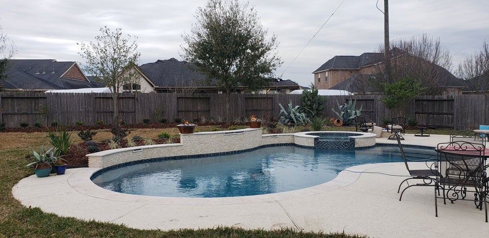 A beautiful inground pool in a Pearland, TX backyard, showcasing high-quality craftsmanship and design