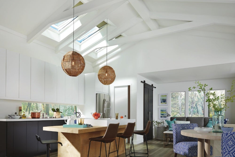 Modern kitchen and living area enhanced by Houseworks Daylighting Solutions' expert skylight installation.