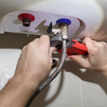 A professional plumber working in a residential setting